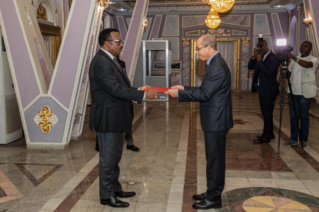 Boukemmache Abdallah handing the advance copies of his lettres of credence to Felix Mbayu.